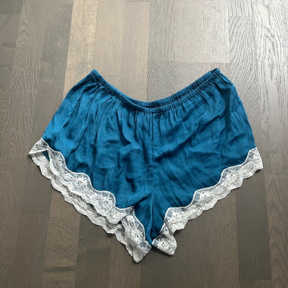 Urban Outfitters out from under silk blue shorts with lace trim